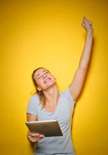 photo of a woman holding an ipad